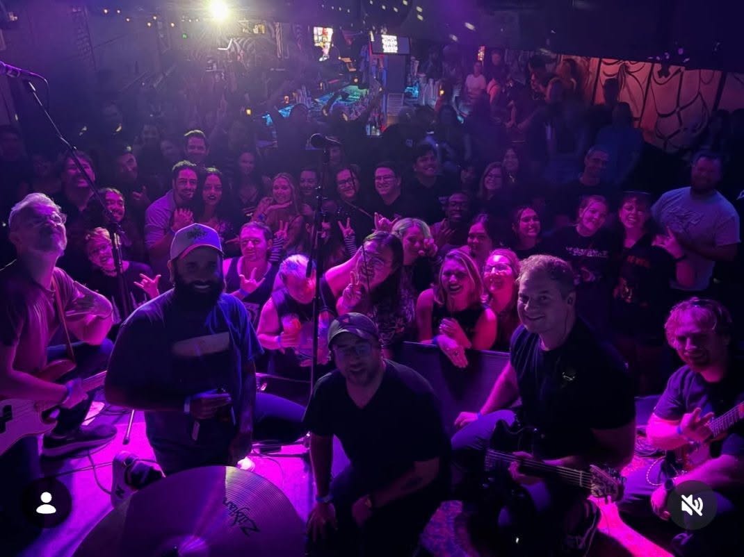 Hollow Coast performing live for a purple-lit crowd